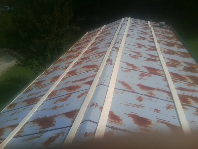 Rusted metal roof panels with new wood purlins before replacement — Storm Damage Roof Repair in Lake Jackson by Roofing Brothers